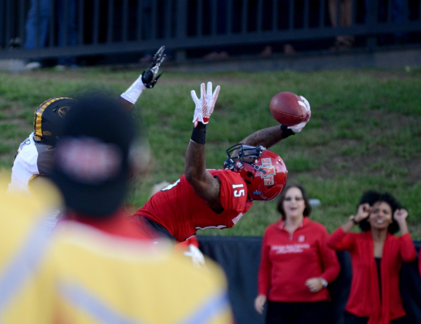 Arkansas State wide receiver Tres Houston, #15, catches a pass  at the game against a Missouri player in the second quarter of their game, September 12, 2015 at Centennial Bank Stadium in Jonesboro, Ark. Missouri defeated Arkansas State University 27-20. | Photo By: Kayla Macomber