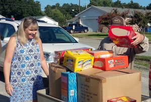 Kristie Ford, counselor of Paragoulds Baldwin Elementary School, reacts to the donated supplies. PLWC's Volunteerism Committee makes an annual donation of backpacks and food for local children in need. (Photo by Kimberely Blackburn) 