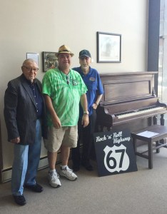 Ace Cannon, Henry Boyce and Sonny Burgess stand beside Porky’s piano.